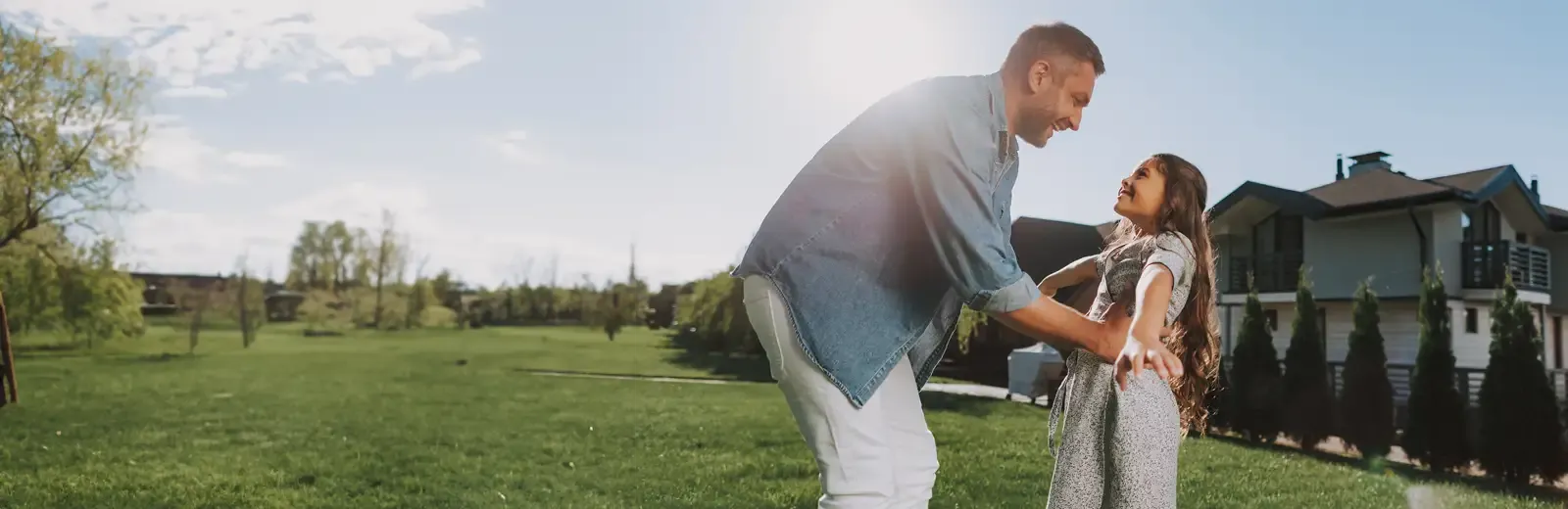 father and daughter playing outside mosquito free lawn